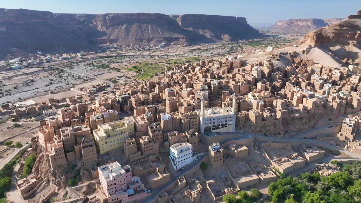 Wadi Doan canyon in Hadhramaut, Yemen, with mud-brick villages and palm groves, a highlight of Mainland Yemen tours.