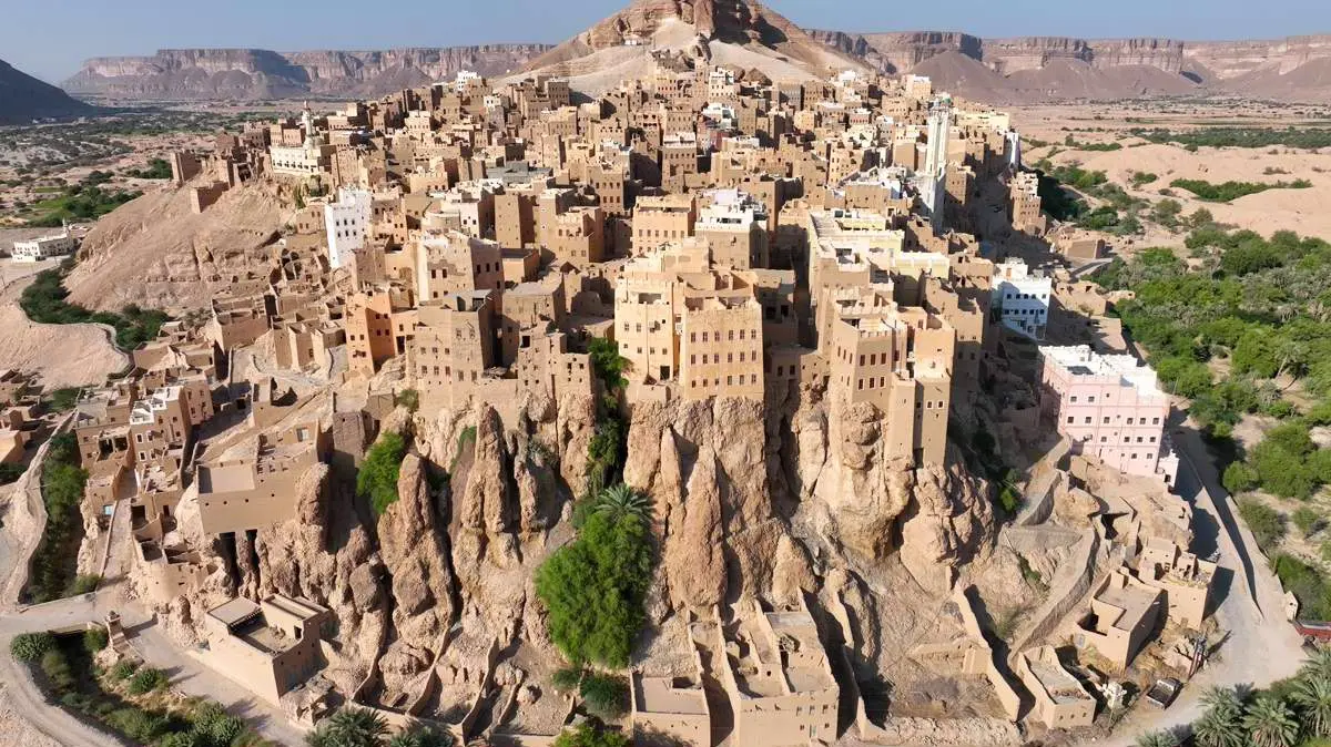 View of Al-Hajarayn mudbrick village built on a rocky cliff in Wadi Doan, Yemen