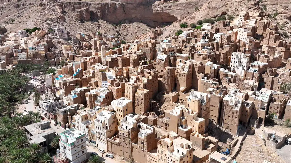 Al-Khuraybah mudbrick village surrounded by cliffs in Wadi Doan mainland Yemen group tour